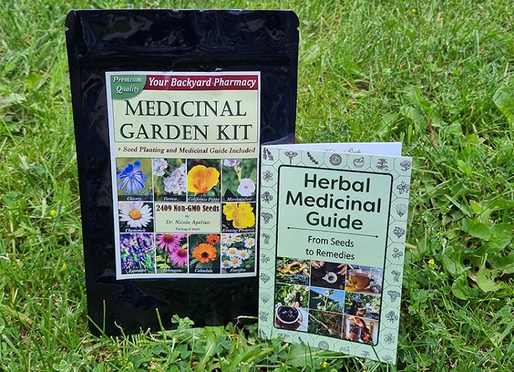 Medicinal Garden Kit package and herbal medicinal guide displayed outdoors on grass